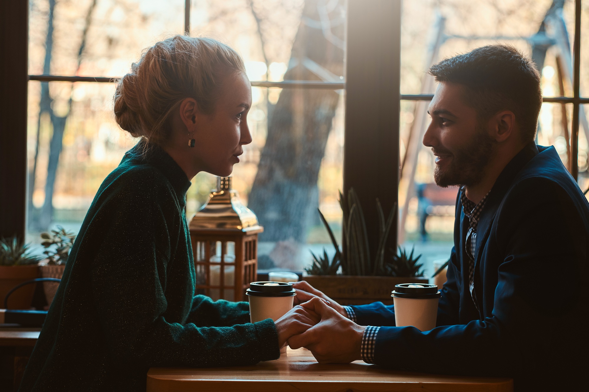 Romantic couple is sitting at cafe at their date