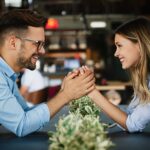 Romantic loving couple drinking coffee, having a date in the cafe.