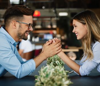 Romantic loving couple drinking coffee, having a date in the cafe.