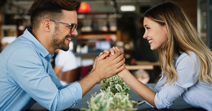 Romantic loving couple drinking coffee, having a date in the cafe.